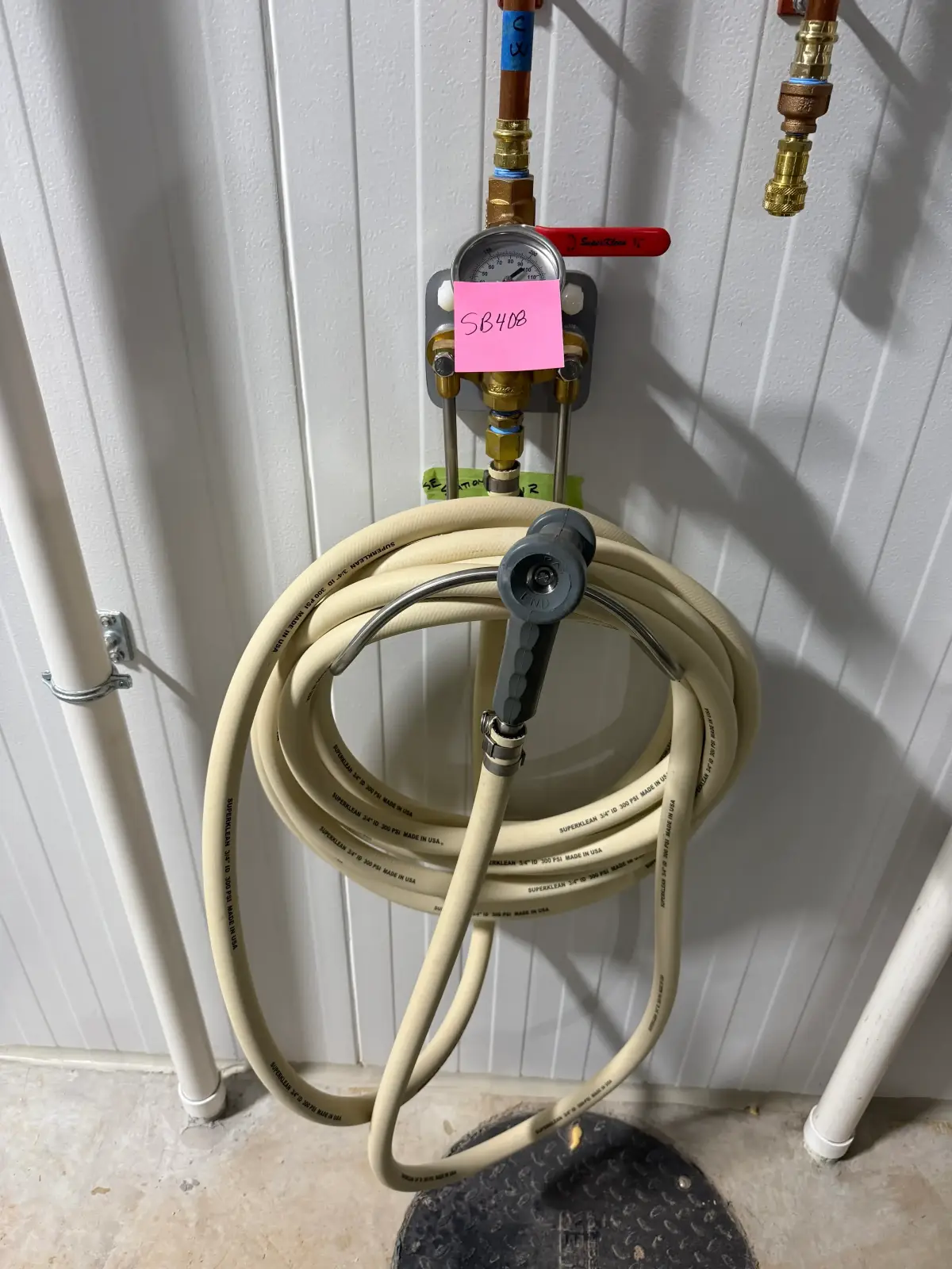 Wall-Mounted Industrial Washdown Hose Station with Pressure Gauge and Spray Nozzle