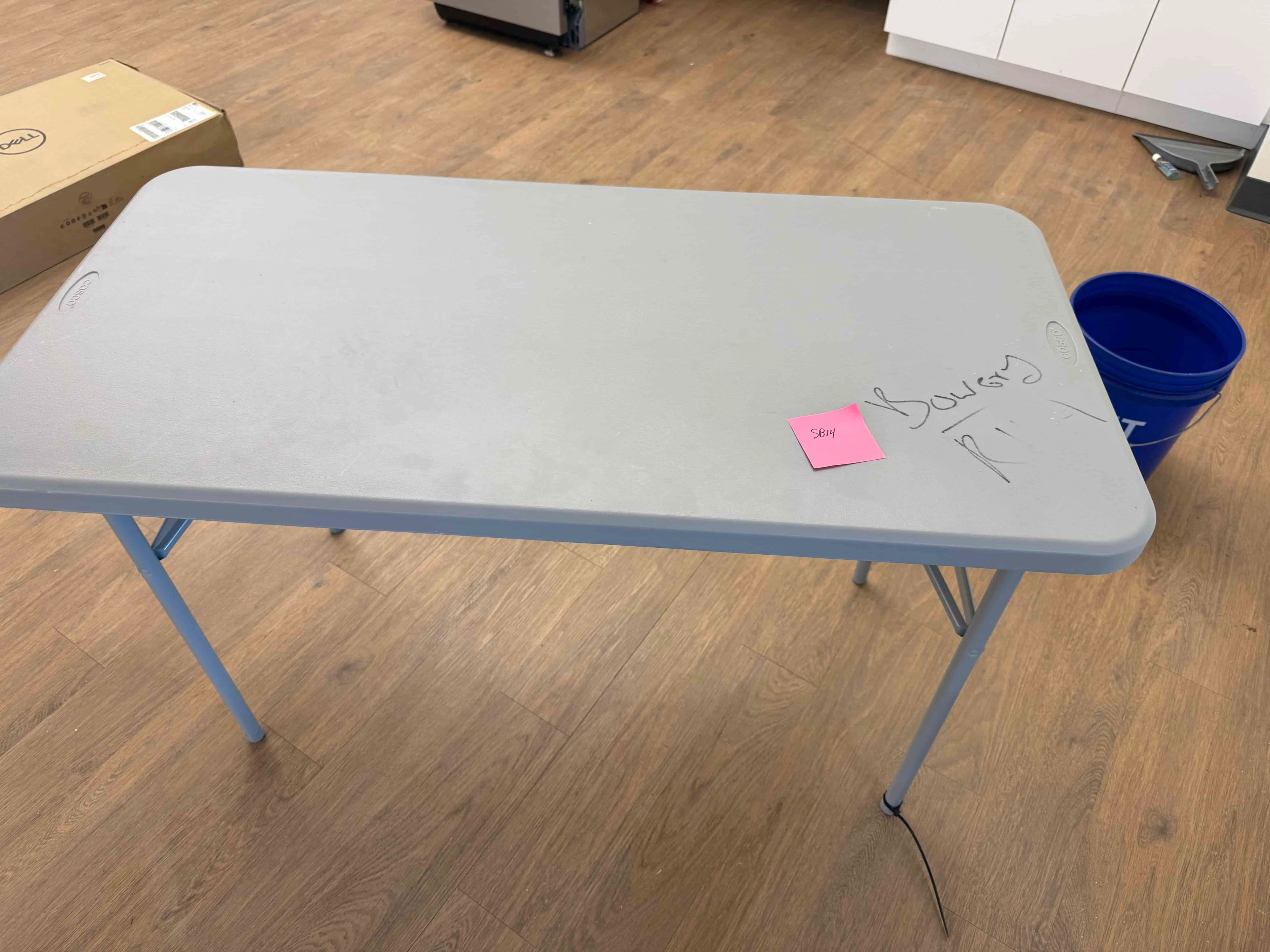 SB14: Cosco lightweight folding utility table with gray plastic top and steel legs