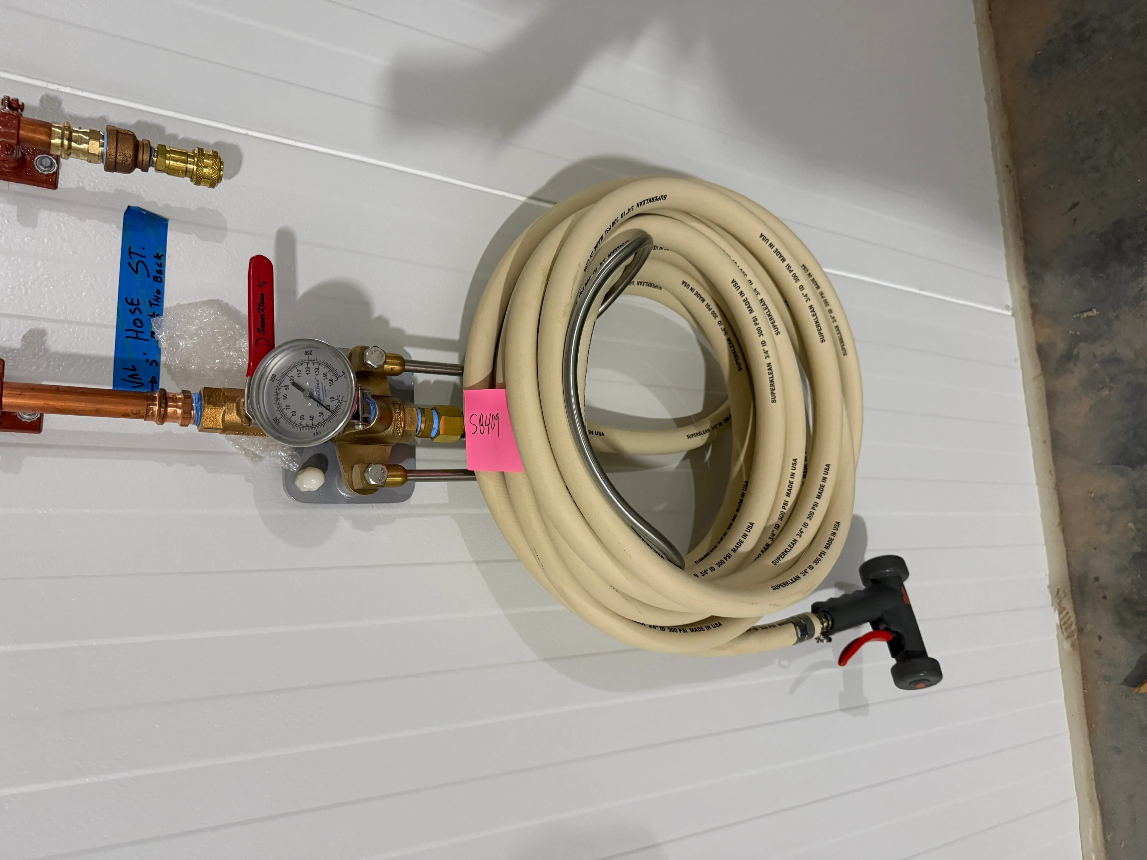 Wall-Mounted Industrial Washdown Hose Station with Pressure Gauge and Spray Nozzle