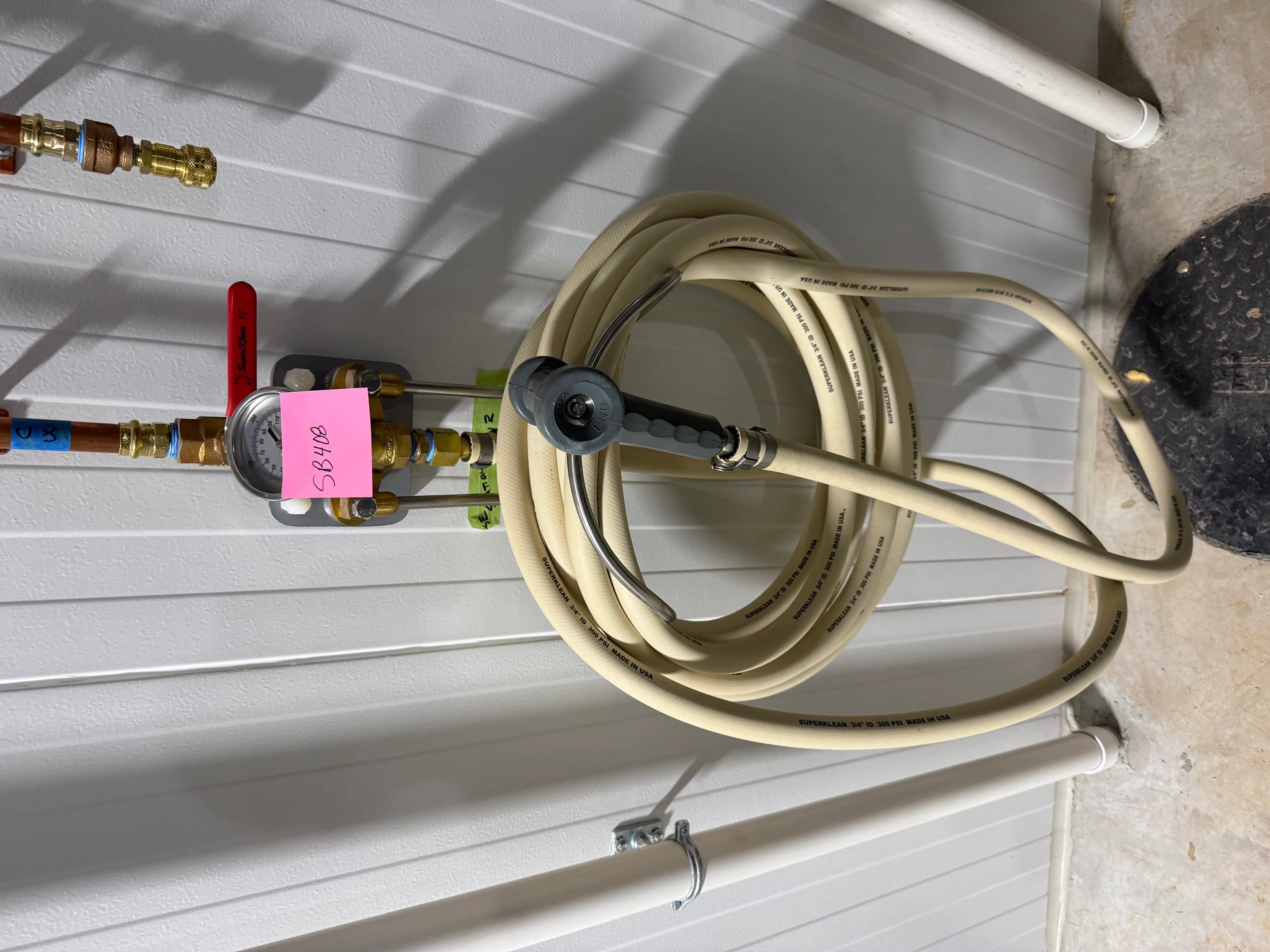 Wall-Mounted Industrial Washdown Hose Station with Pressure Gauge and Spray Nozzle