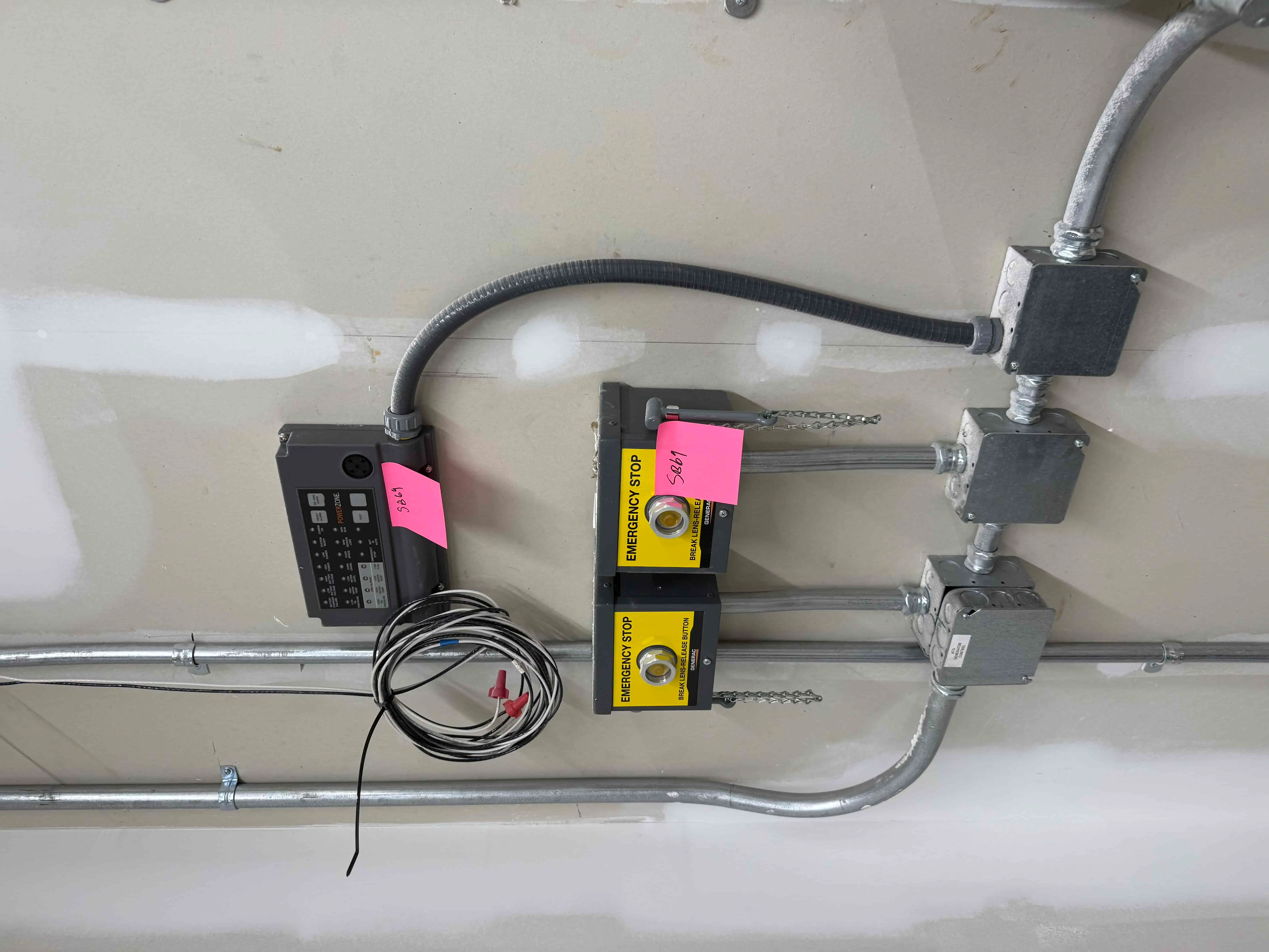 SB69: Generac / ASCO PowerZone Generator Control Panel with Dual Emergency Stop Stations – Wall-Mounted Safety and Monitoring System for Backup Power Integration