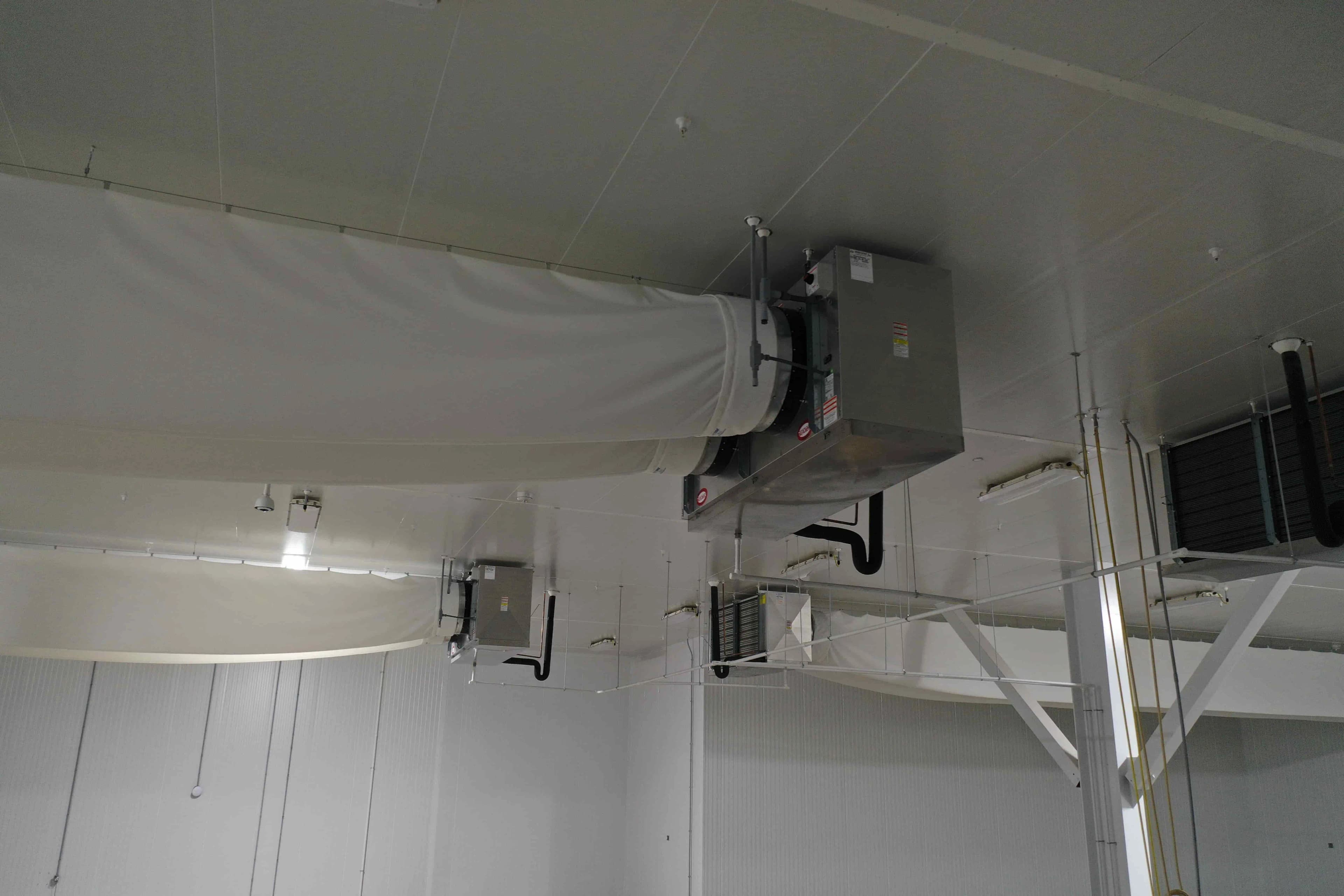 SB6023a: EVAP 2A Evaporative Cooler – Trenton THP106ME-T4A-SN Dual-Fan High-Profile Evaporator with Fabric Duct (~15,000 CFM, 460 V 3-Phase) – EVAP 2A Located Mid-North Wall of 37 °F Cold Pack Room