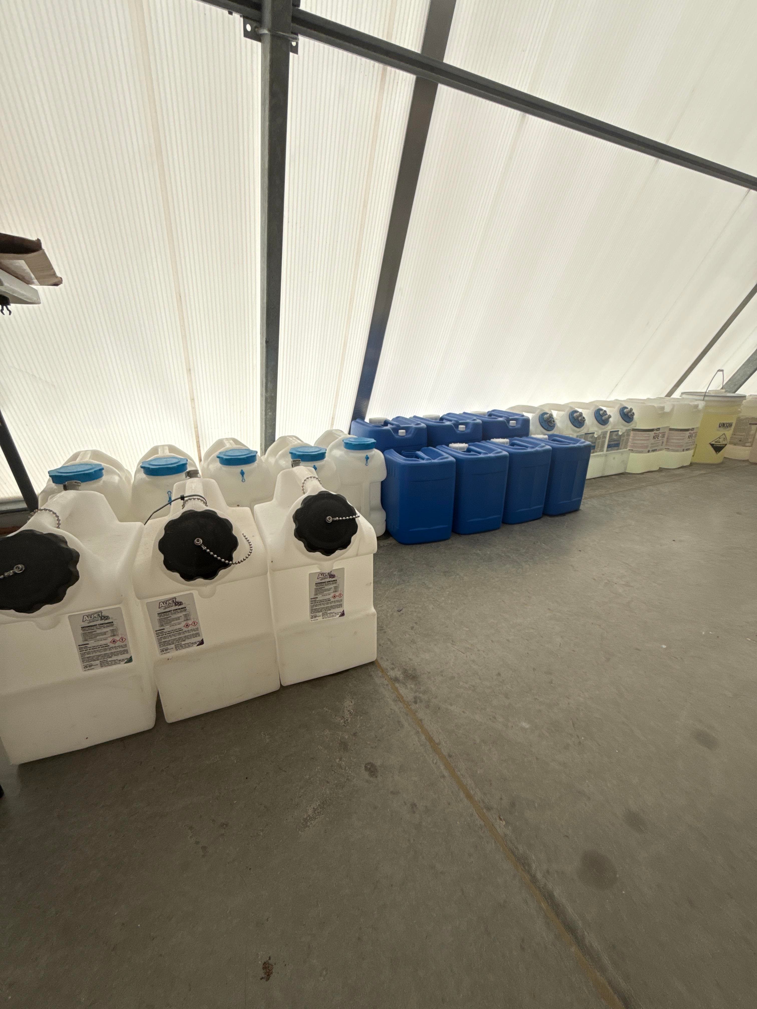 Mixed Chemical Storage Tote Lot with Plastic Jugs, Carboys and Containers
