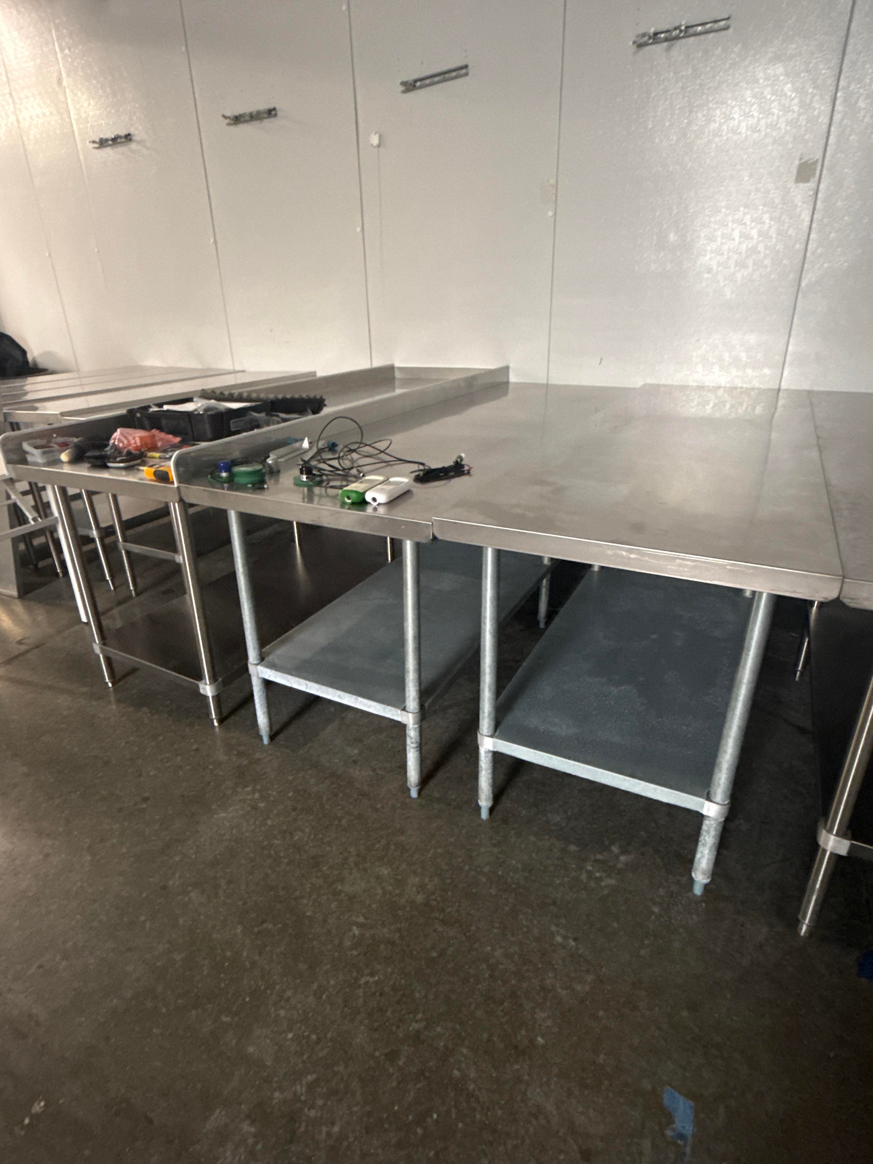 Three Stainless Steel Commercial Work Tables with Undershelves, One with Backsplash